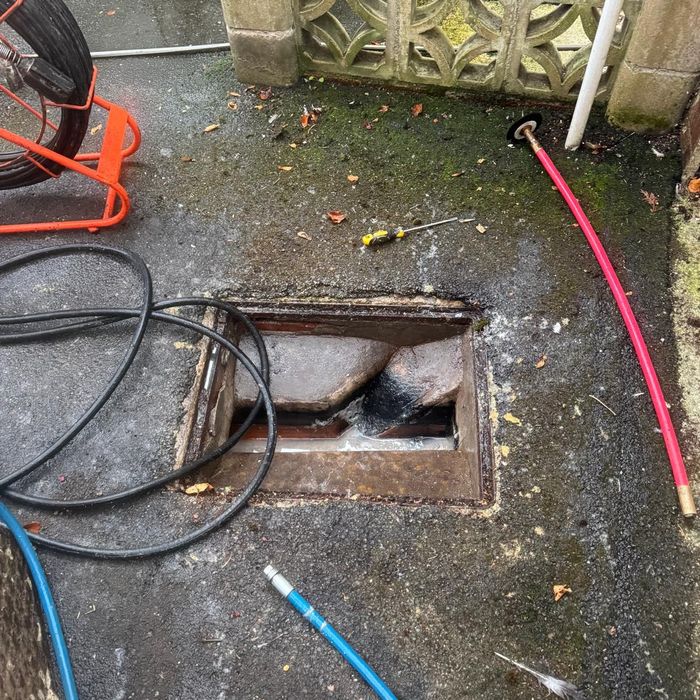 Clean Clear Drains jetting equipment set up at an outdoor drain